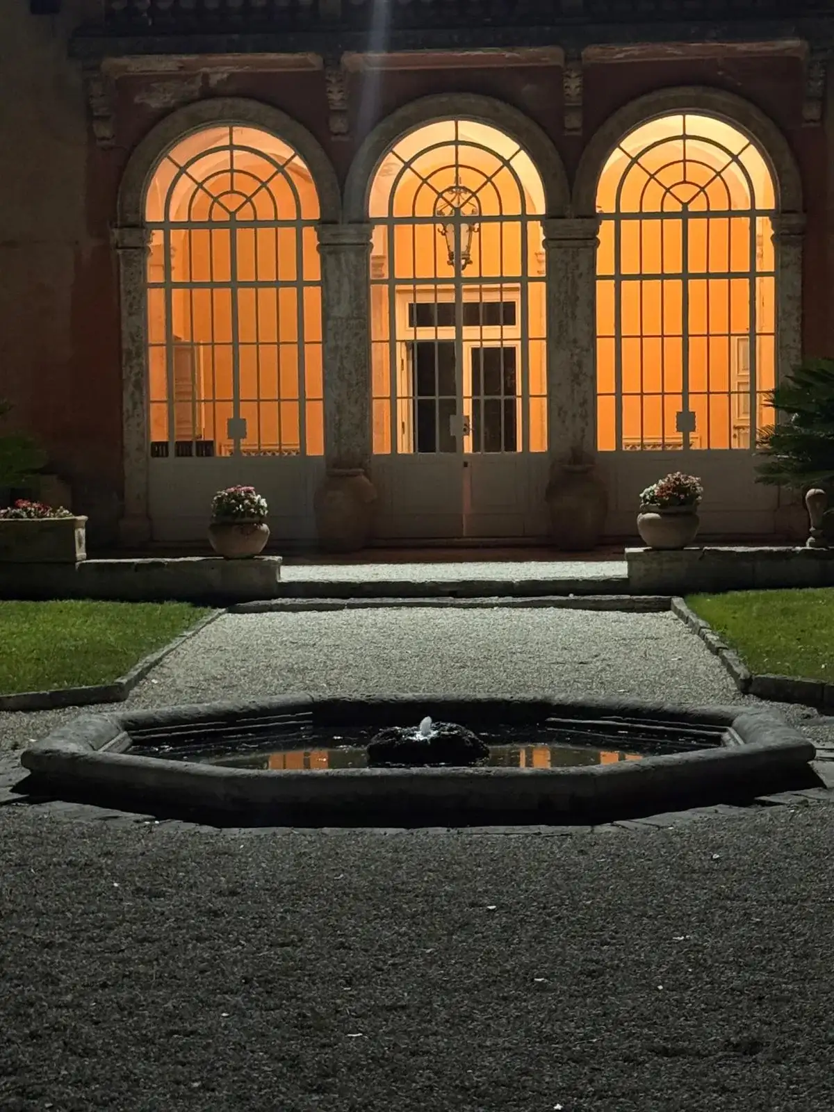 The limonaia and fountain at dusk