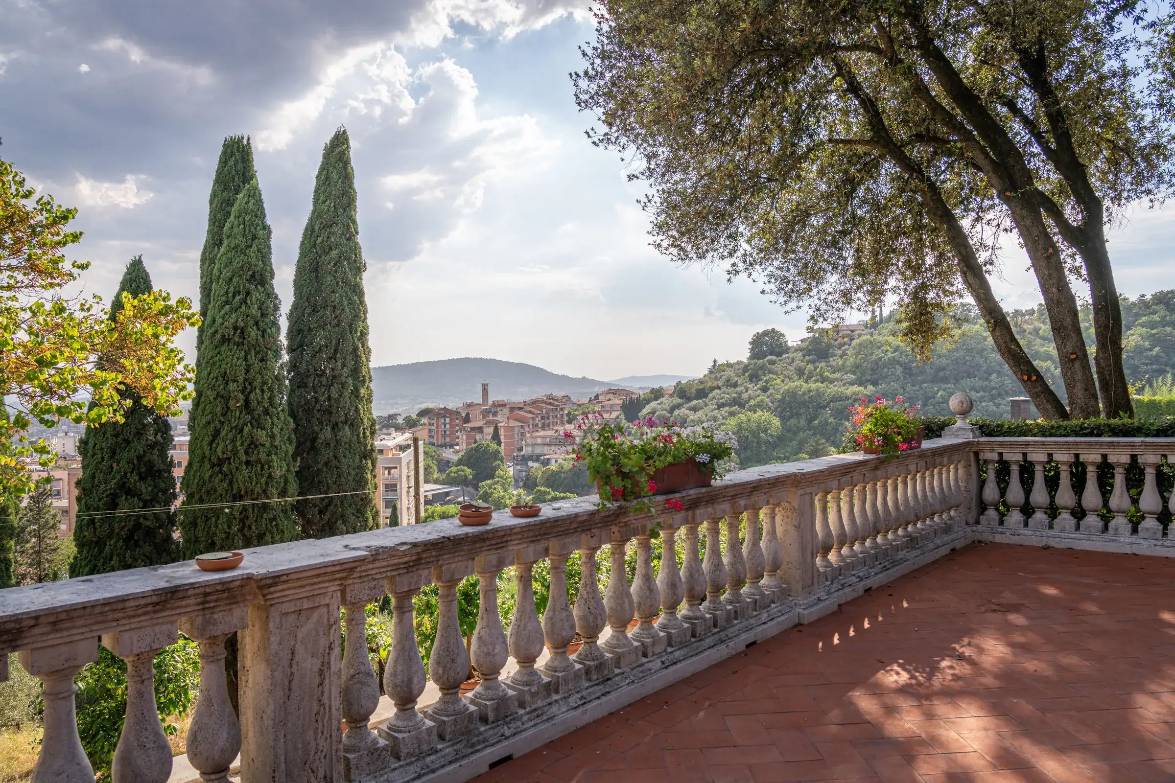 Balustraded terrace overlooking cypresses and the Umbrian hills