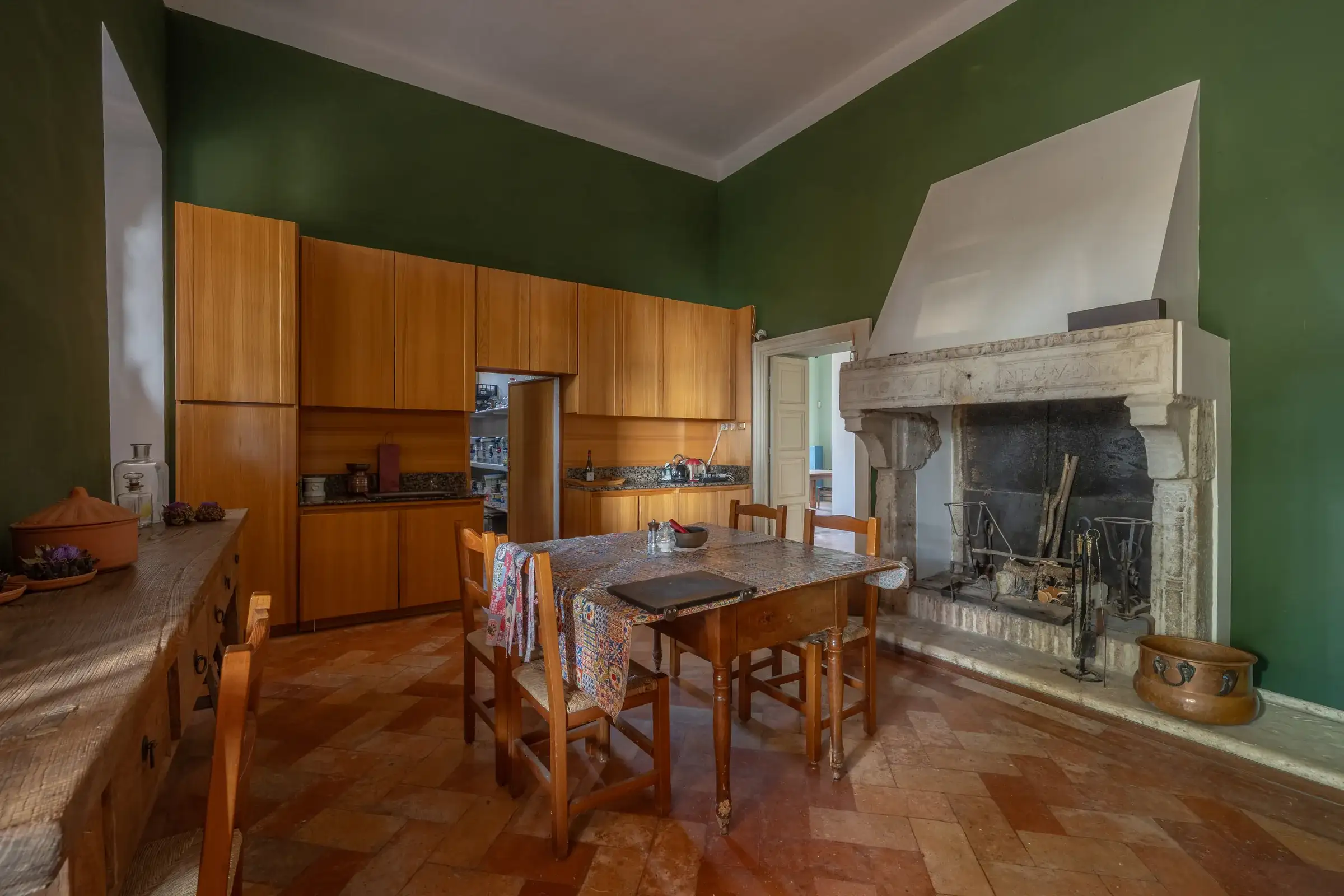 Kitchen with a monumental stone fireplace