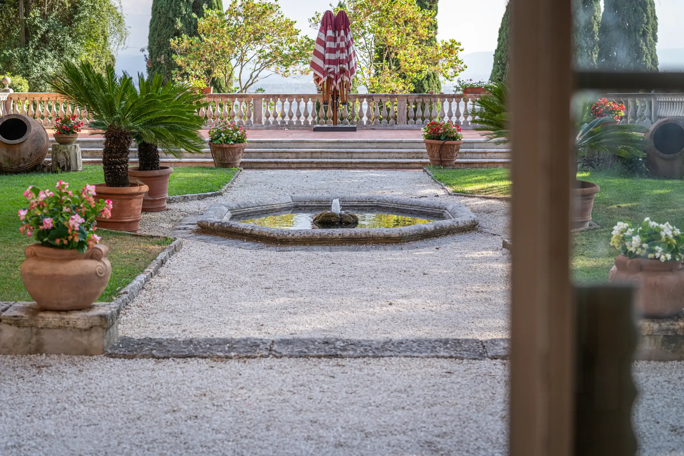 Formal Italian garden with fountain and potted citrus trees